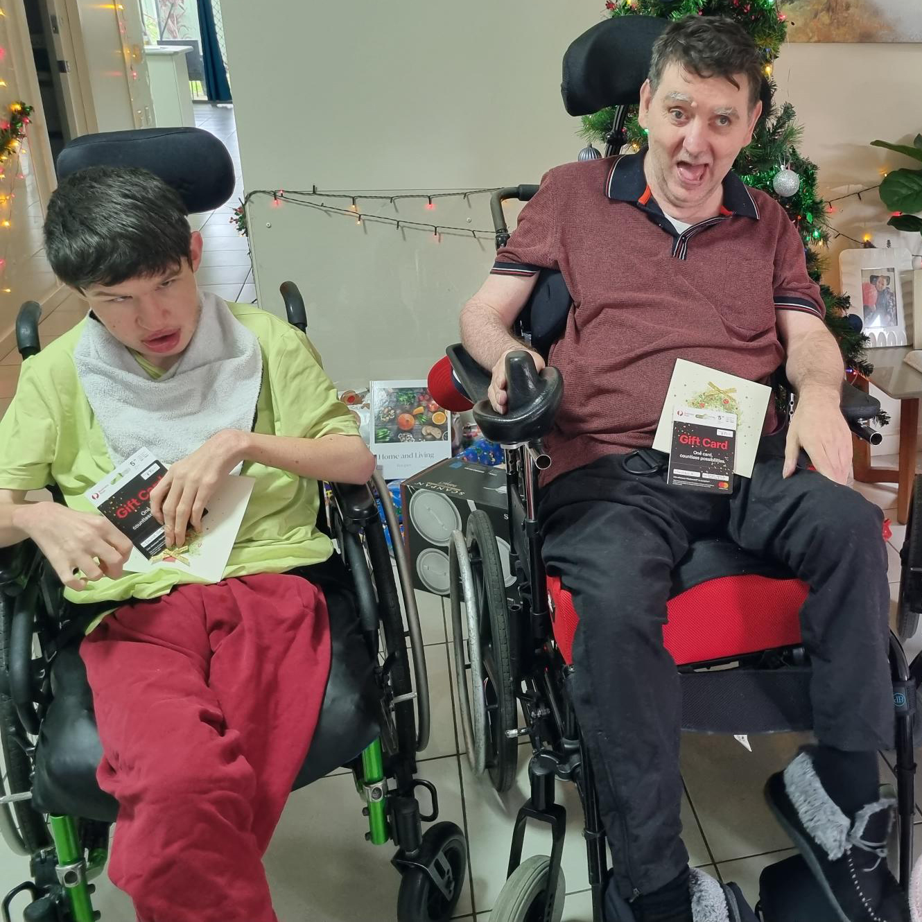 2 male Breakthru clients holding their Christmas cards & $50 gift vouchers